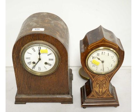 An Edwardian walnut inlaid mantel clock, raised on four gilt metal whorl feet, 26.5cms high; together with a Victorian oak ca