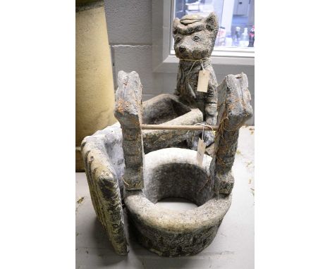 A 20th Century stone composite garden planter/birdbath, formed as a uniformed fox pushing a wheelbarrow, on naturalistic base