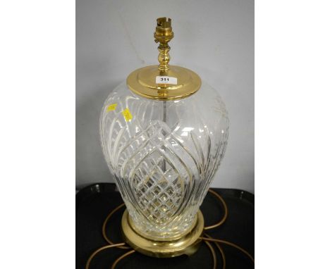 A Waterford crystal 'Kilkenny' table lamp, with brass mounts and circular base, 49cms high, lacking shade. 