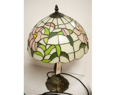 A Tiffany-style table lamp, the stained glass shade decorated with pink roses and leaves, 48cms high overall.