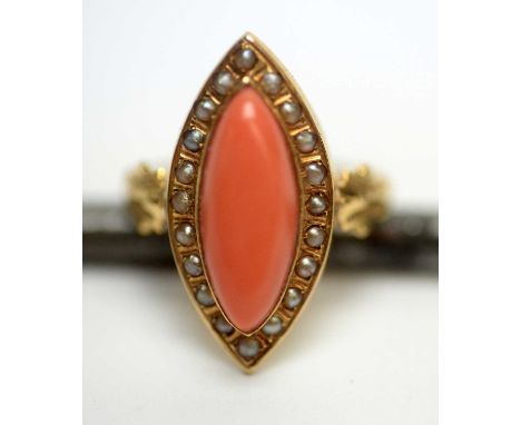 An Edwardian coral and seed pearl cluster ring, in marquise shaped mount, on yellow metal shank, ring size N, 2.4g gross. 