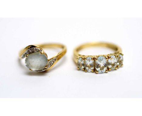 A five stone aquamarine ring, on 9ct yellow gold shank, ring size N; and another aquamarine ring, set with diamonds in crosso