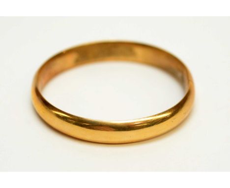 A yellow metal bangle, stamped '14k', 6.4cms wide, 14.2g gross. 