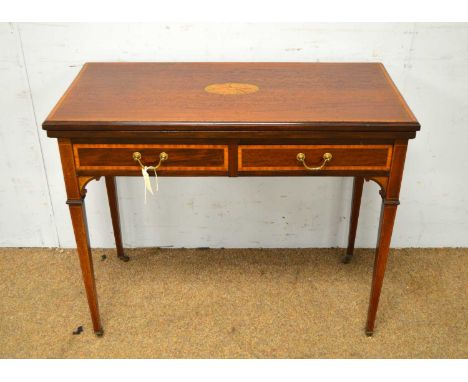 An Edwardian inlaid fiddle back mahogany and satinwood banded card table, hinged swivel top with baize playing surface, two f