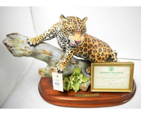A hand-painted Renaissance Design Studio figure of a Jaguar, modelled on tree trunk, designed by Howard J. Wedgwood, modelled