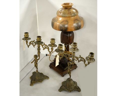 A pair of brass figural candelabra, each modelled as a child, 36cms high; together with a carved wedge table lamp, formed of 