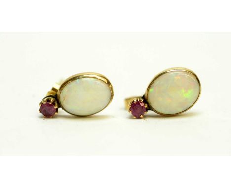 A pair of opal and ruby pendant earrings, in yellow metal mounts. 