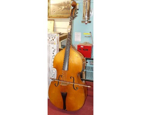 A double bass violin, with bow (2)Damage as shown in photos.No label inside.Would say approx 30-50 years old.Height 188cm. Wi