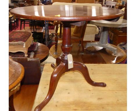 A George III mahogany circular fixed top pedestal tripod occasional table, on hipped supports, dia. 79.5cm