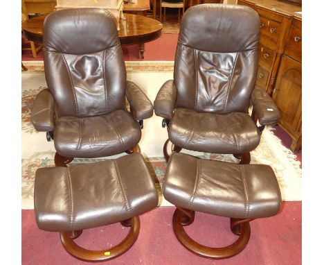 A pair of contemporary Stressless formed laminate framed and chocolate brown leather upholstered swivel reclining armchairs, 