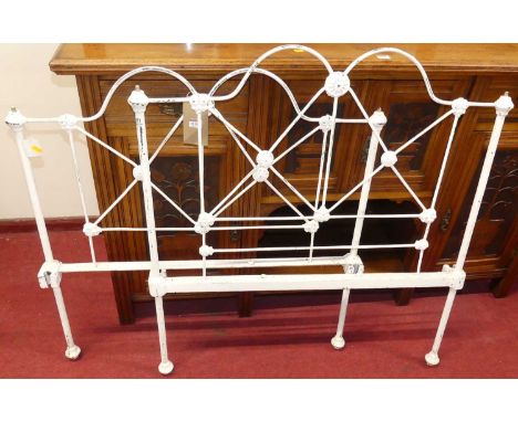 A Victorian and later white painted iron single bedstead (lacking side rails and ball cappings)