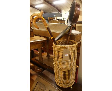 A wicker circular stick stand, with two walking sticks and a copper and brass warming pan (4)