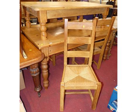 A contemporary pine farmhouse kitchen table, raised on turned supports, length 152cm, and a set of four rush seat ladder back