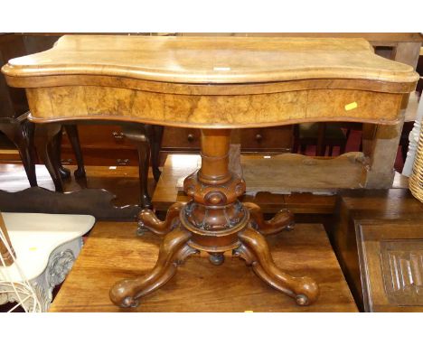A mid-Victorian figured walnut serpentine fold-over card table, having baize-lined interior, swivel top, raised on shaped scr