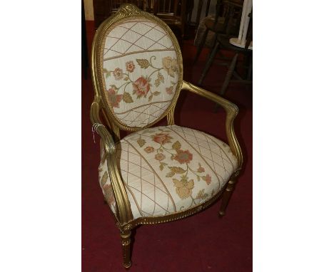 A French giltwood fauteuil, with upholstered back and stuffover seat 