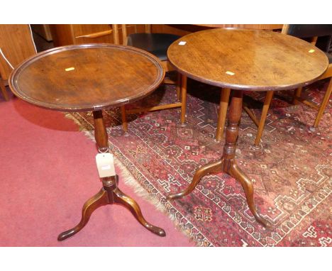 An early 19th century mahogany tilt-top pedestal tripod occasional table on hipped supports, dia. 53cm, together with a furth