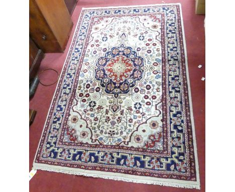 A Persian woollen cream ground Tabriz rug, 183 x 119cm
