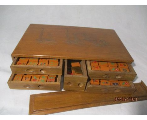 A vintage Mah-jong set in wooden case with incised decoration of junks on a river