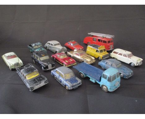 A collection of vintage, play worn die cast Corgi toy cars, plus two Dinky