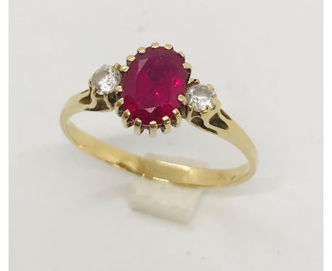 A ruby and CZ three stone ring