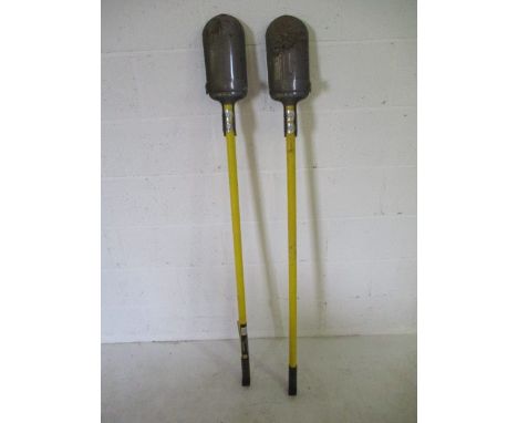 A pair of Roughneck post hole diggers