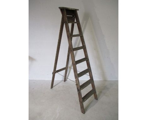 A vintage set of wooden step ladders.