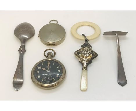 An Ingersoll Defiance 1940's pocket watch along with a silver baby's teething ring, silver spoon and pusher and a compass