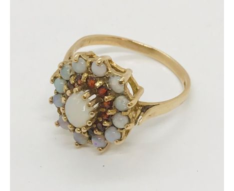 A 9 ct gold opal and garnet cluster ring