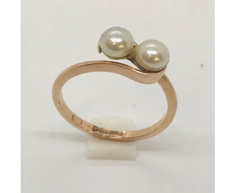 A 9ct rose gold ring set with two pearls