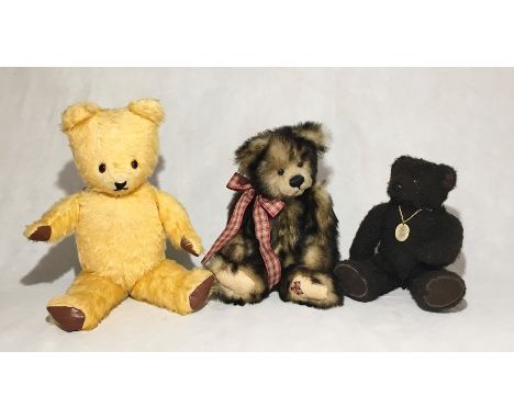 A vintage teddy bear along with two others