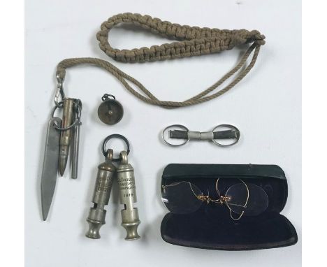 A 1916 A. De Courcy &amp; Co. whistle, one other along with a pair of pince nez, compass etc.