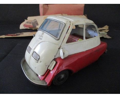 A vintage boxed tin plate friction driven Isetta. Box in poor condition