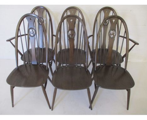 A set of six Ercol stained beechwood Windsor style hoop and stick back dining chairs, with shaped splats and pierced swan det