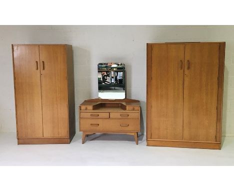 A G-Plan light oak bedroom suite including a dressing table and two wardrobes