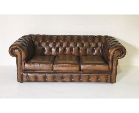 A three seater brown leather Chesterfield sofa 