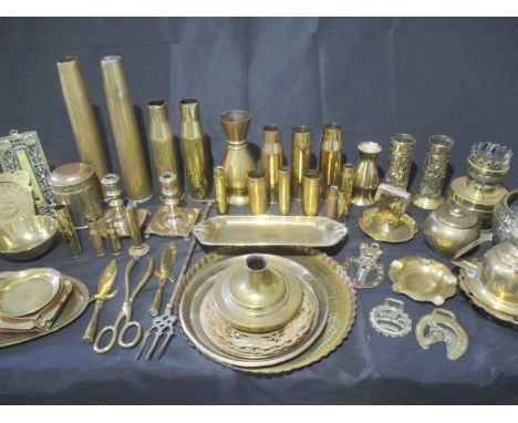 A collection of brassware including shells, vases, ashtrays, candlesticks, matchbox holder etc