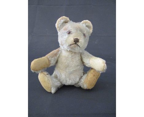 A vintage plush teddy bear with jointed arms and legs, height approx. 16cm