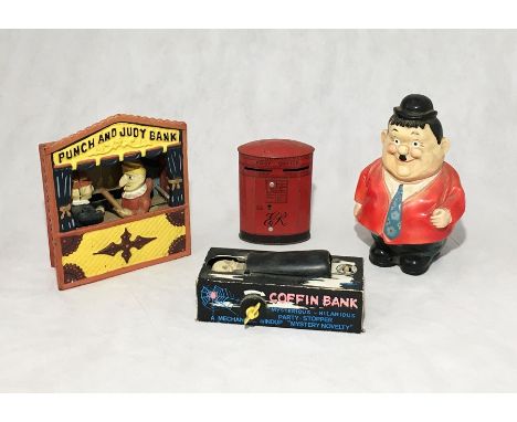 A collection of vintage novelty money boxes including a reproduction metal Punch and Judy Bank