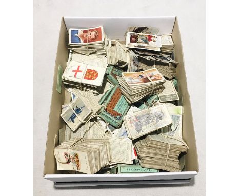 A box of assorted cigarette cards along with a collection of vintage playing cards
