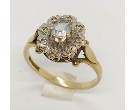 A 9ct gold ring with blue topaz &amp; diamond chips