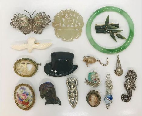 A collection of costume jewellery including a continental silver butterfly brooch, apple jade bangle, carved jade roundel etc