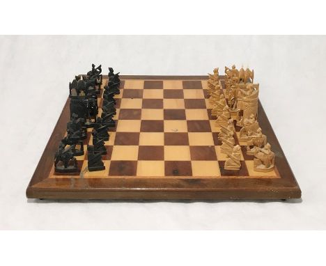 A carved wooden Asian chess set on wooden board with velvet lined carry case 