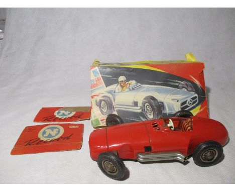 A vintage Mercedes Benz friction driven, tin plate model racer, Made in West Germany by NF.  Car No 82.