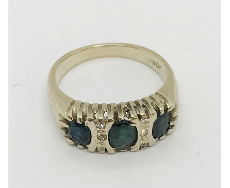 An 18ct white gold sapphire three stone ring with diamond infills, weight 6.2g 