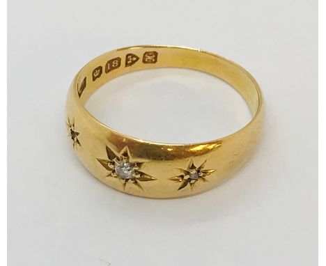 An 18ct gold gypsy ring with single diamond ( two smaller diamonds flanking central stone missing), weight 3.2g