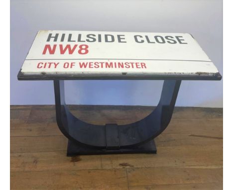 An enamel street sign, Hillside Close NW8, City of Westminster, set into the top of a table, 107 cm wide 