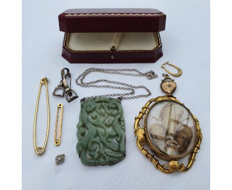 A Chinese carved and pierced jade pendant, in a silver coloured metal mount, on a chain, a late Victorian large hair plait br
