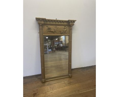A gilt gesso pier mirror, decorated a chariot, 108 x 66 cm 