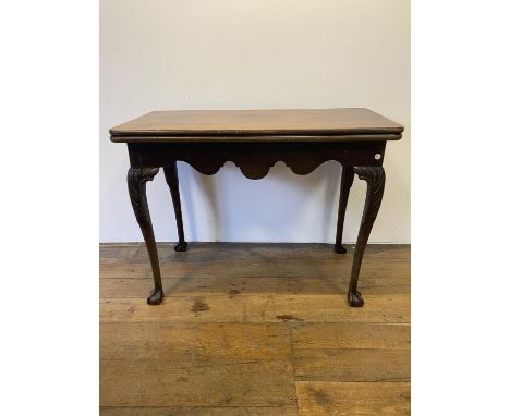 A 19th century mahogany folding card table, on carved cabriole legs to ball and claw feet, 97 cm wide 