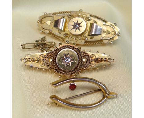 GOLD BAR BROOCHES comprising 15ct gold diamond set bar brooch, 9ct gold diamond set bar brooch and 9ct gold ruby set wishbone